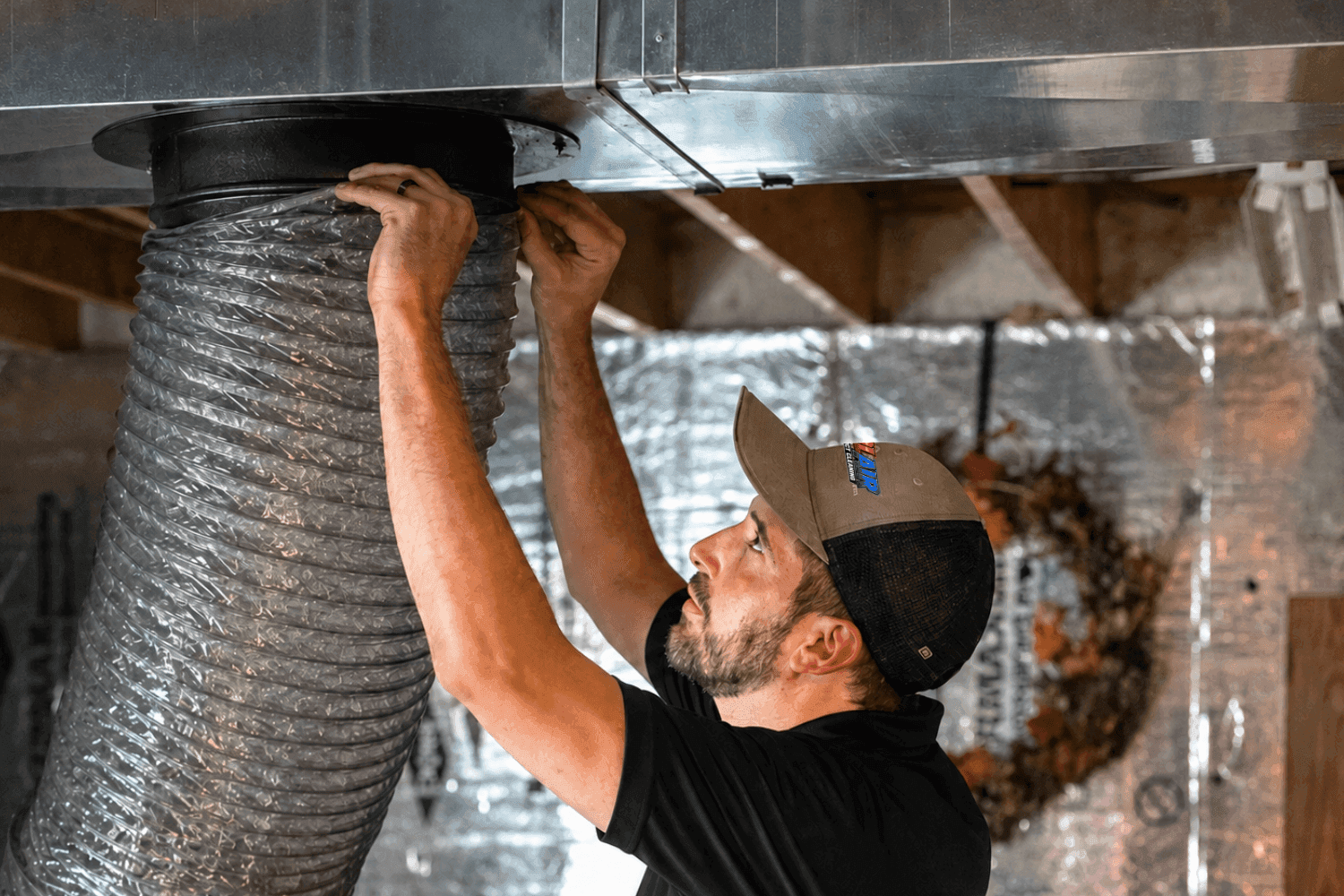 Colair technician connecting a flex duct during a duct cleaning in Ottawa